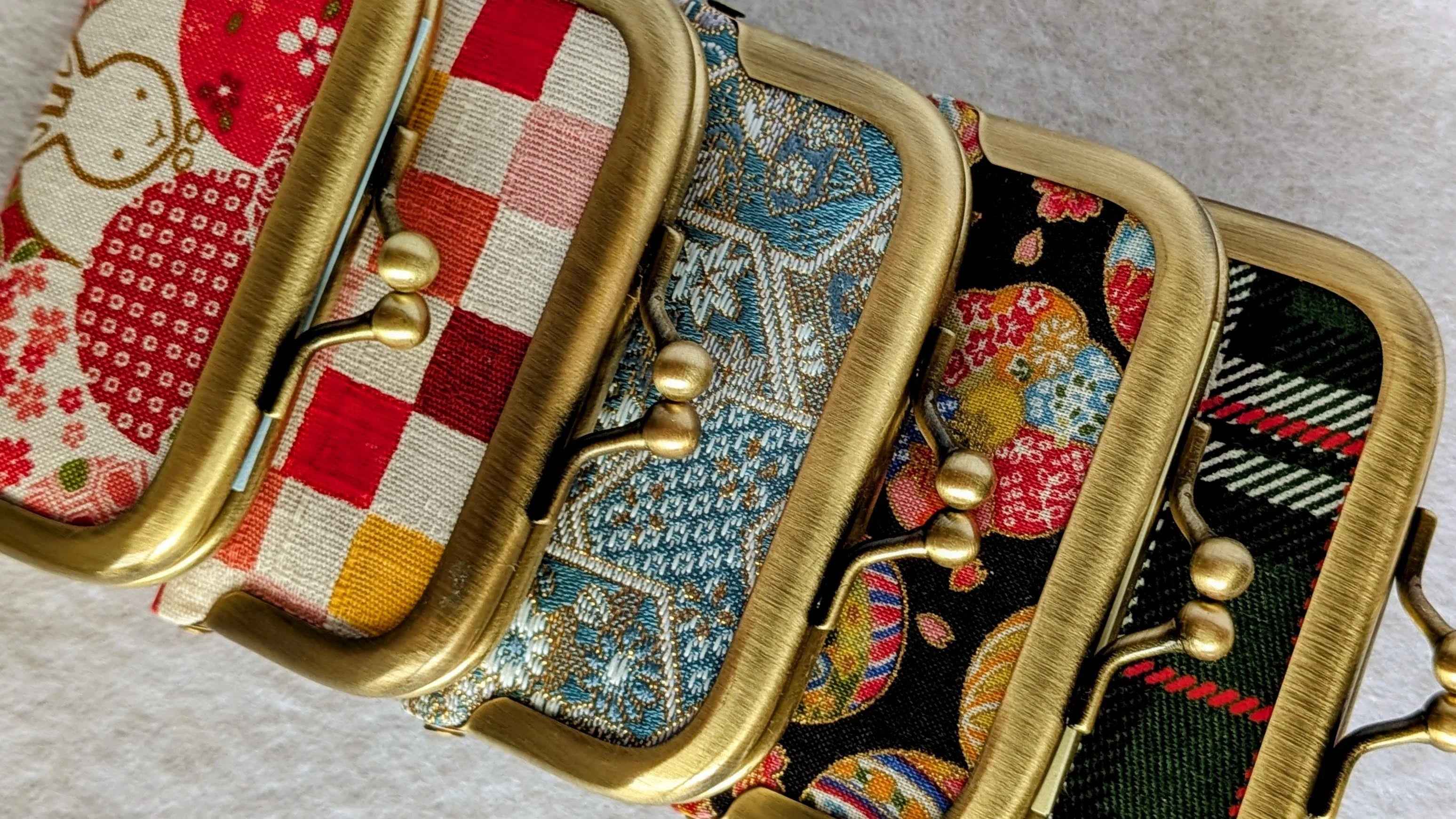 Close-up of handmade gamaguchi pouches in a variety of fabrics and colors