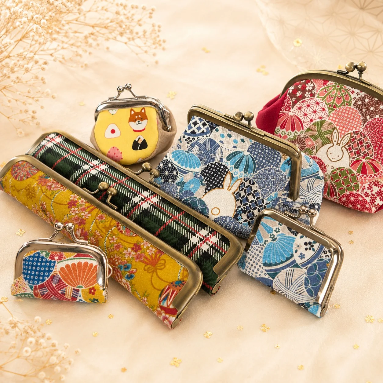 A selection of handmade gamaguchi pouches in colorful patterned fabrics.