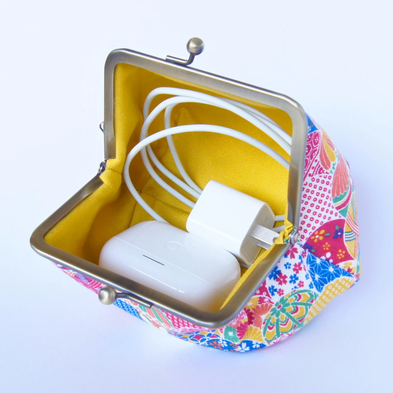 Earphones and cables stored in the open pouch