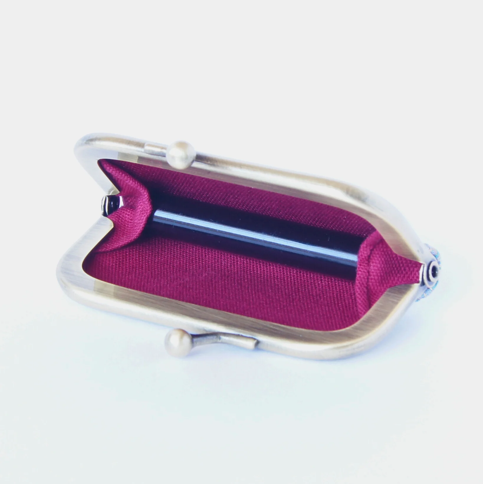 A stamp held in place by the purse's inner gusset