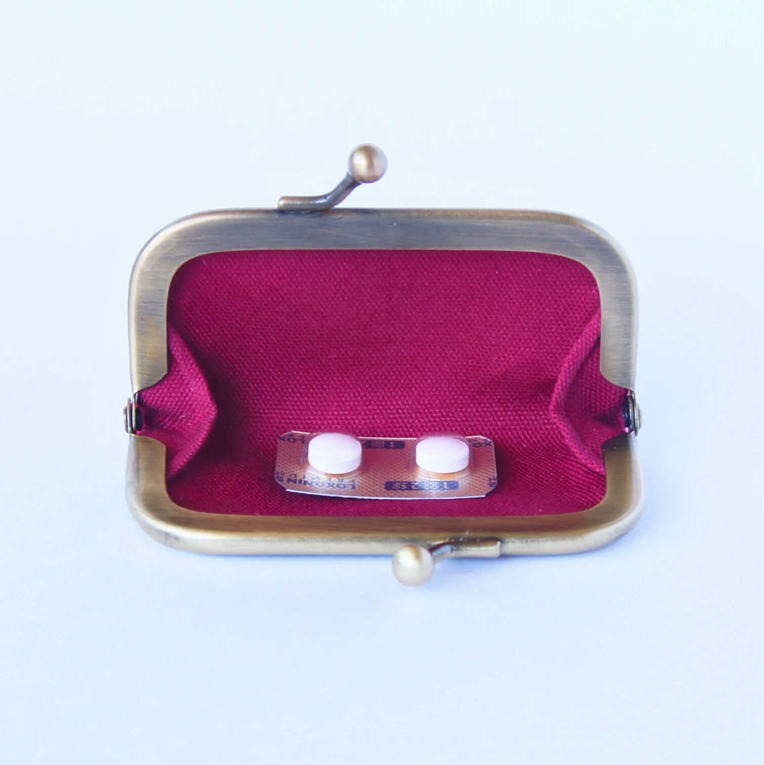 Pills stored in the compact purse