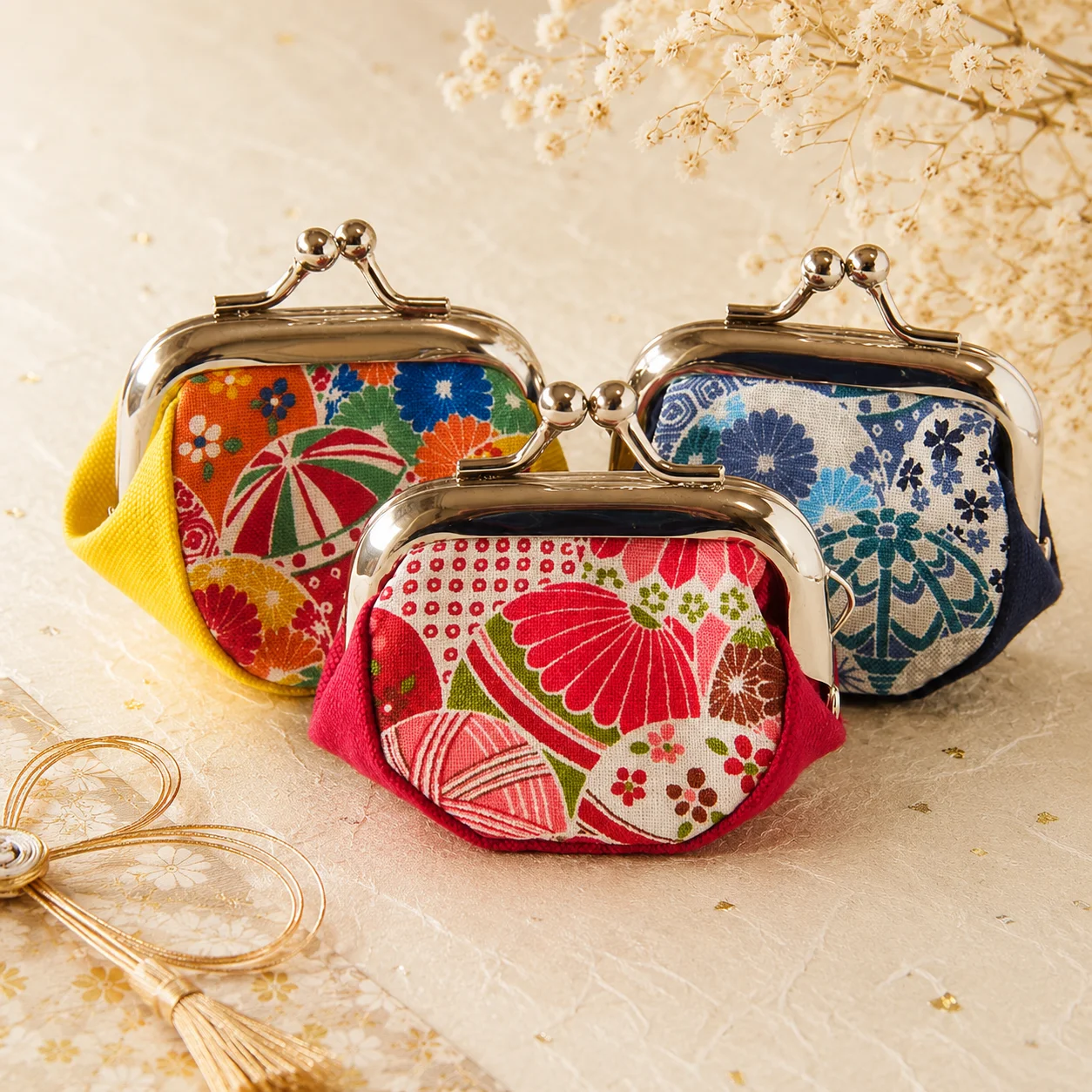 Palm-sized gamaguchi coin purse with mari handballs and cherry blossom motifs
