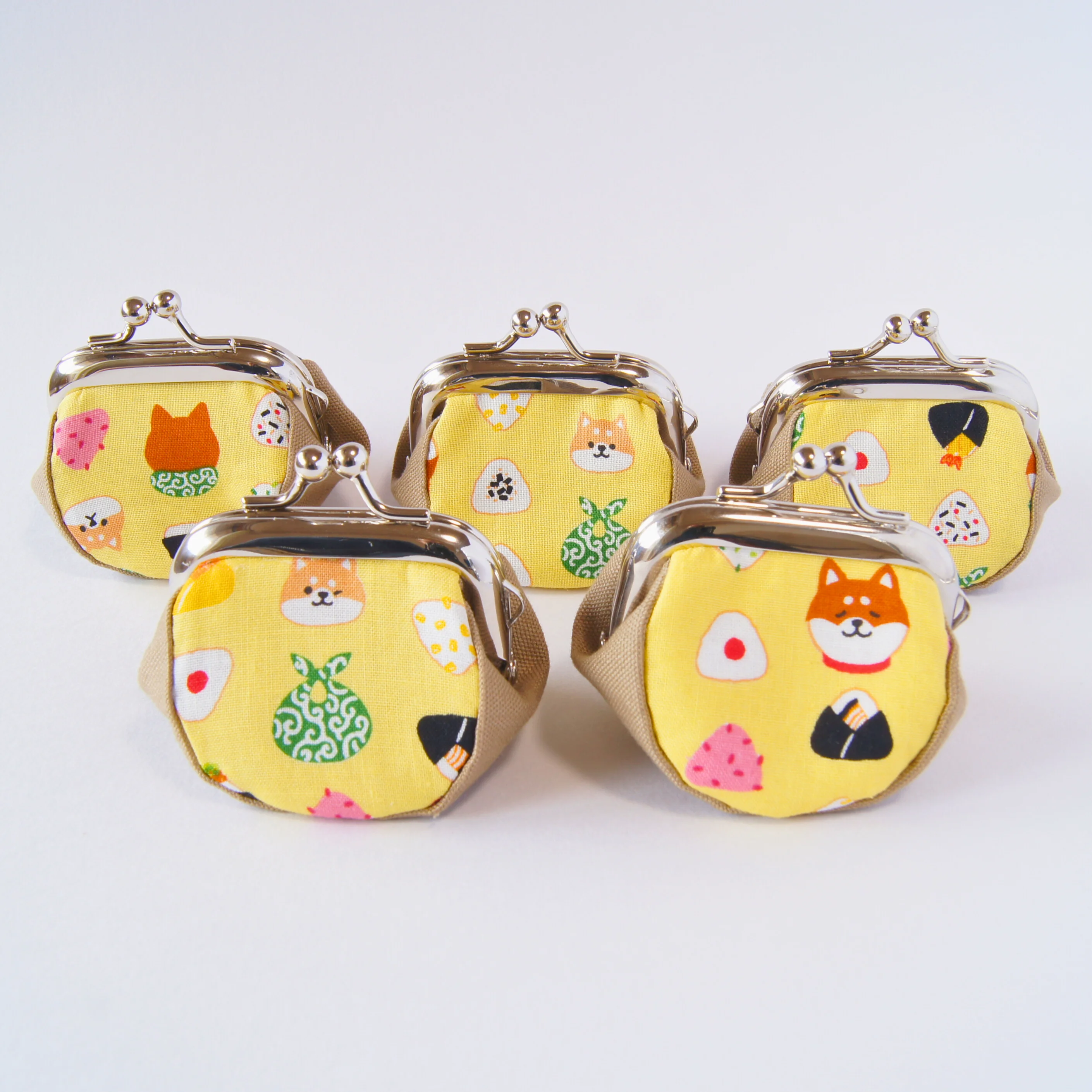 Different Shiba Inu faces shown on each side of the purse
